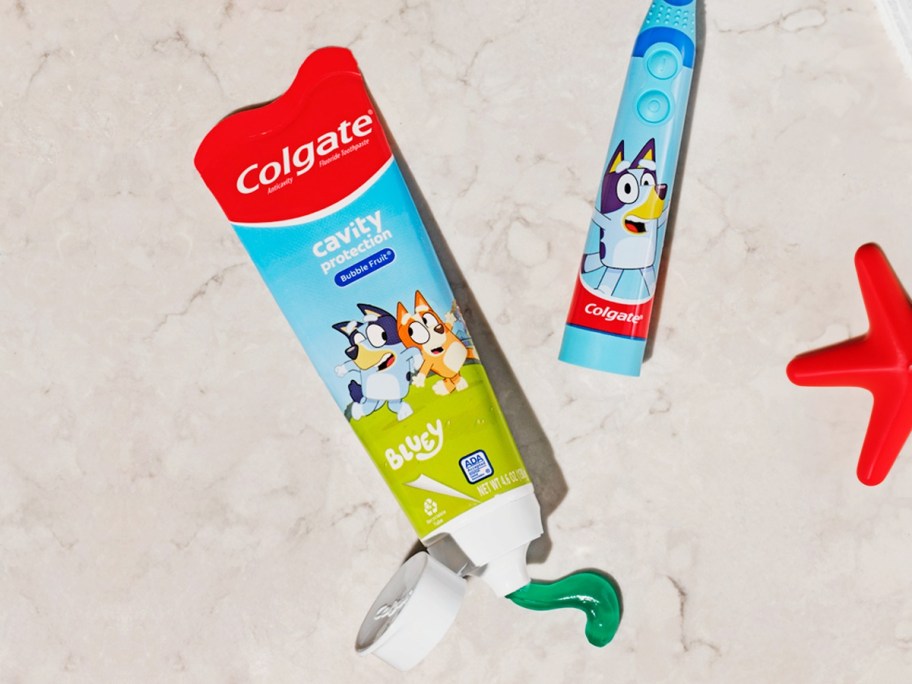 tube of colgate bluey toothpaste on counter near bluey toothbrush