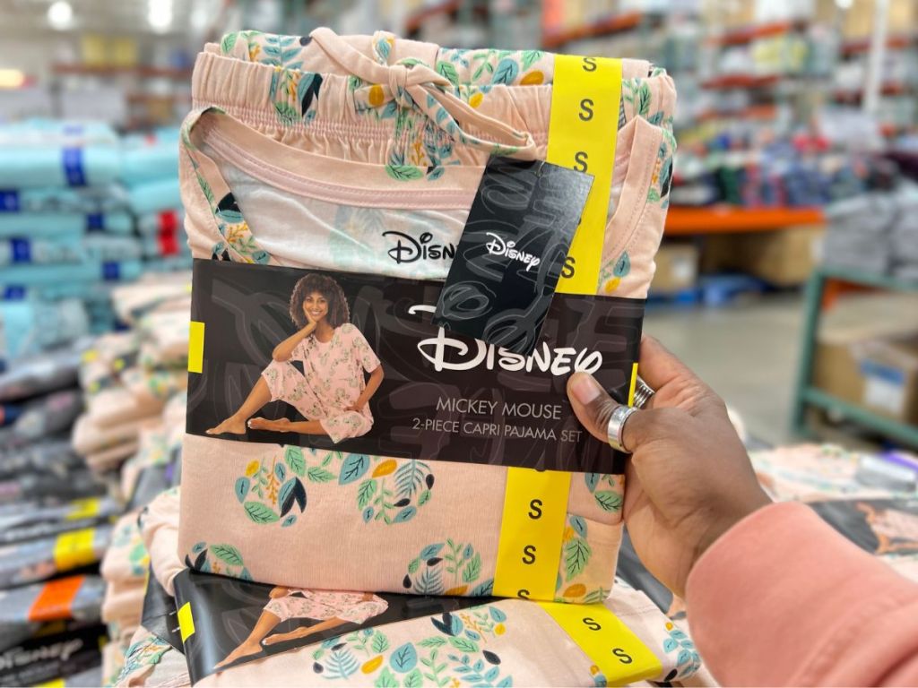 A hand in Costco holding Women's Disney Mickey Mouse Pajamas