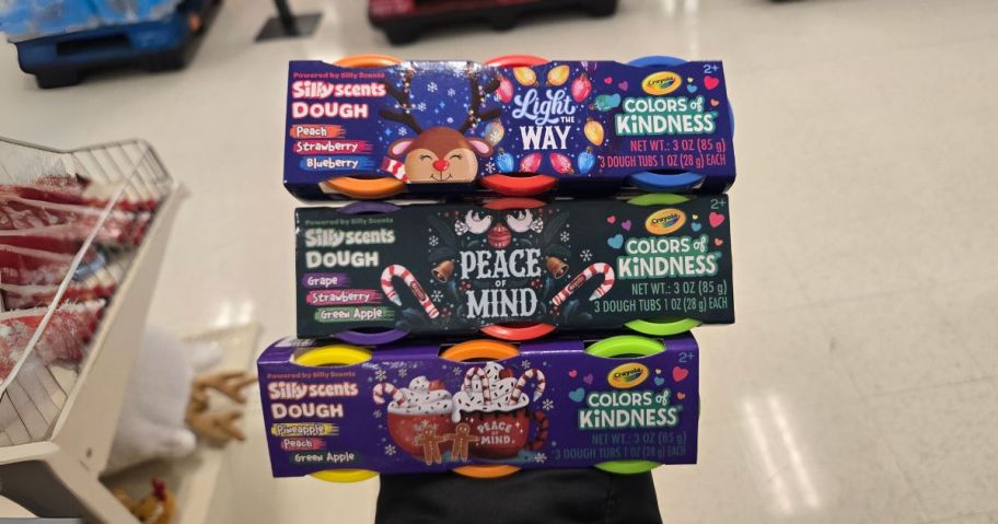 three Crayola Play-Dough Christmas Colors of Kindness Sets in hand in store