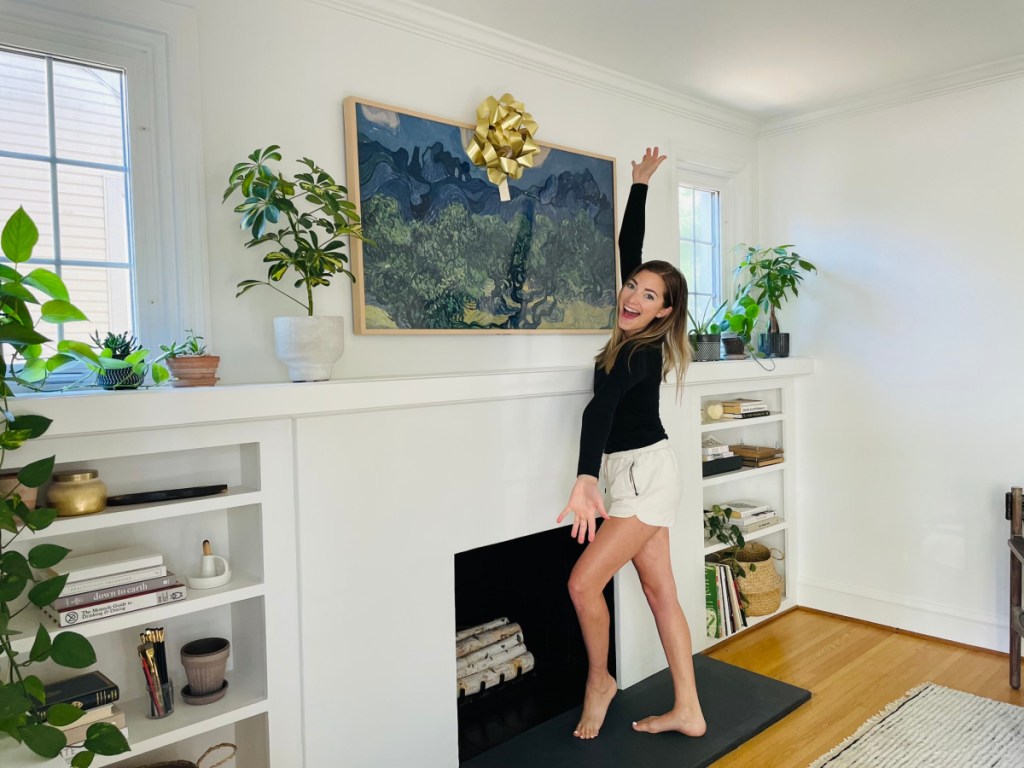 Woman standing next to her Samsung Frame TV