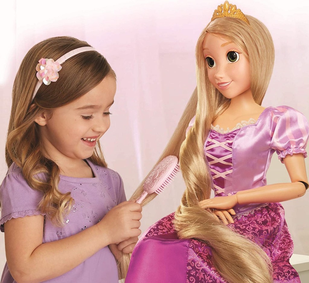 Girl brushing dolls hair