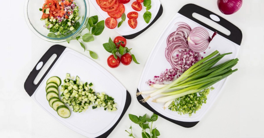 black and white cutting boards covered in food