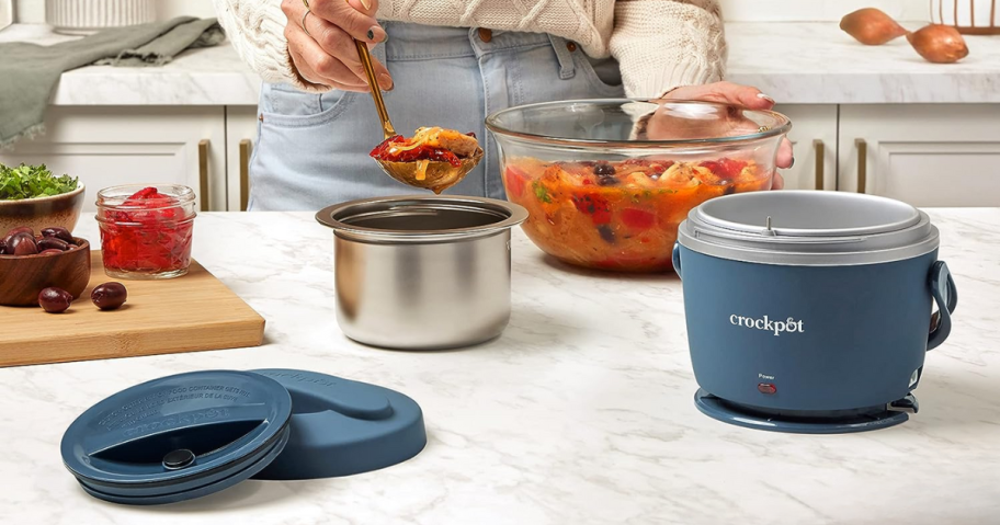 Woman putting food into a Crockpot™ 20-oz. Lunch Crock Food Warmer