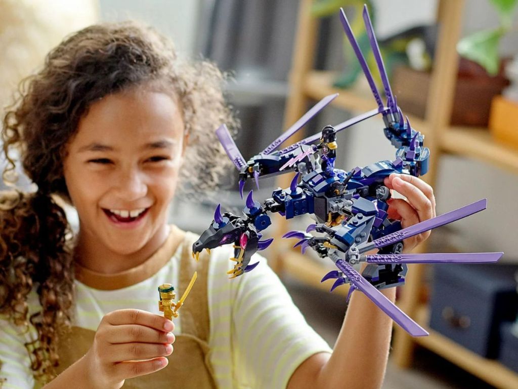 girl playing with a LEGO Ninjago Set