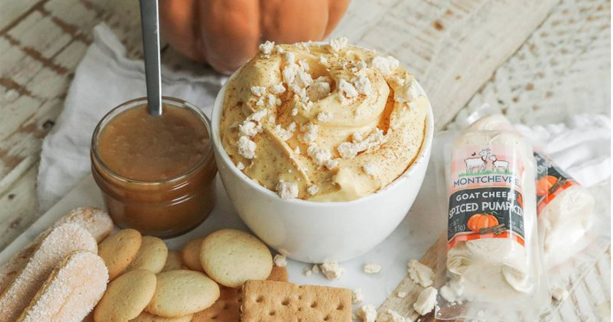 montchevre goat cheese in a bowl near crackers and cookies and a pumpkin spread