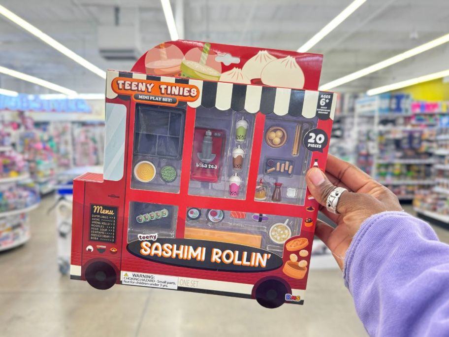 hand holding a Teeny Tinies foodies mini play set in the shape of a Sushi Food Truck