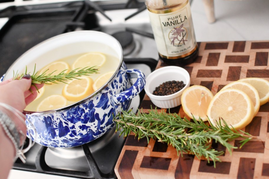 adding ingredients to a simmer pot recipe