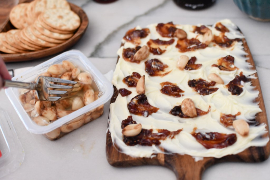 adding roasted garlic to butter board