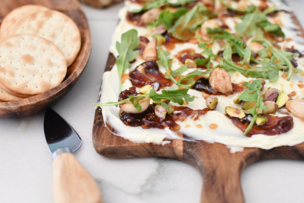 butter board with knife and crackers on the side