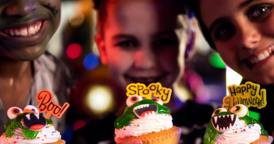 3 kids holding Halloween Cupcakes