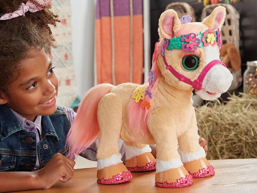 girl playing with furreal pony 