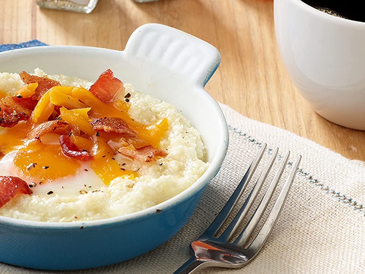 bowl of grits and cheese and bacon and egg