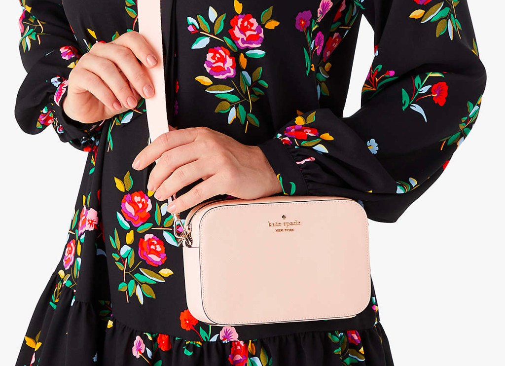 woman wearing light pink kate spade purse