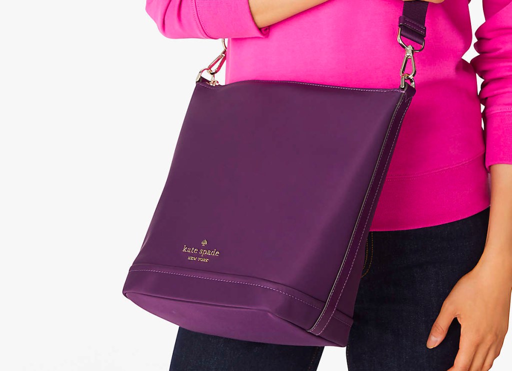 woman holding purple kate spade duffle