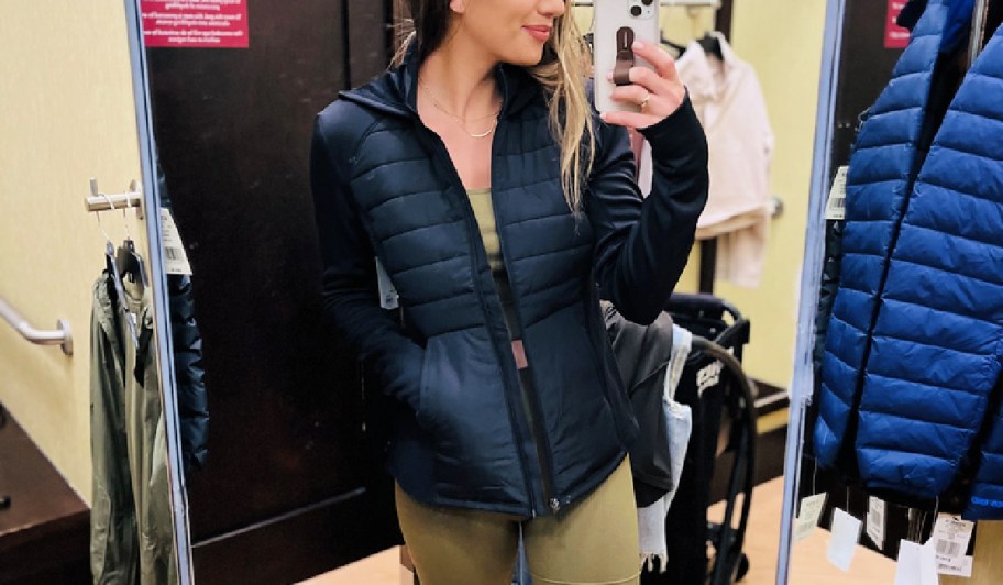 woman wearing a kohl's tek gear women's jacket in a fitting room