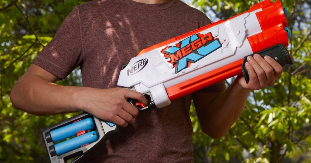 teen holding nerf mega xl blaster outdoors