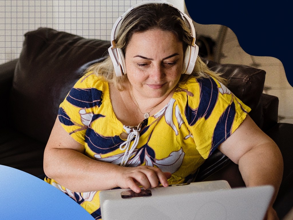 woman wearing headphones and using laptop