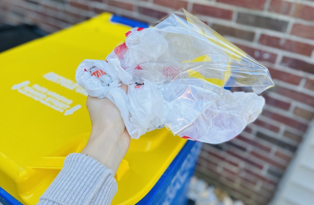 hand holding balled up plastic bags 