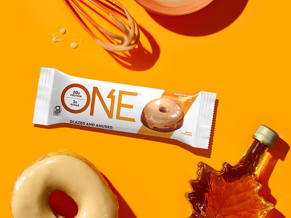 protein one glazed doughnut bar next to glazed doughnut and maple syrup