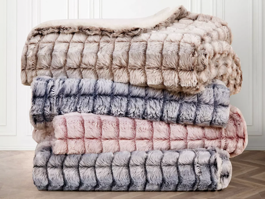 stack of folded throw blankets