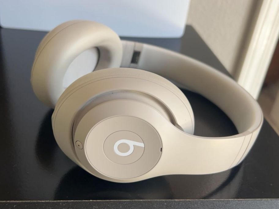 Beats Studio Pro Wireless in Sandstone on a desk