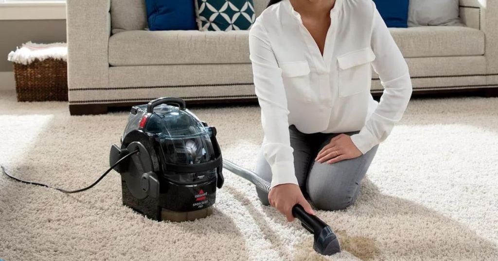 woman cleaning with Bissell SpotClean Pro Portable Deep Cleaner