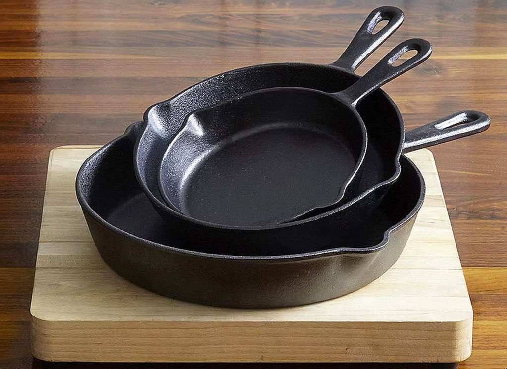 three cast iron pans