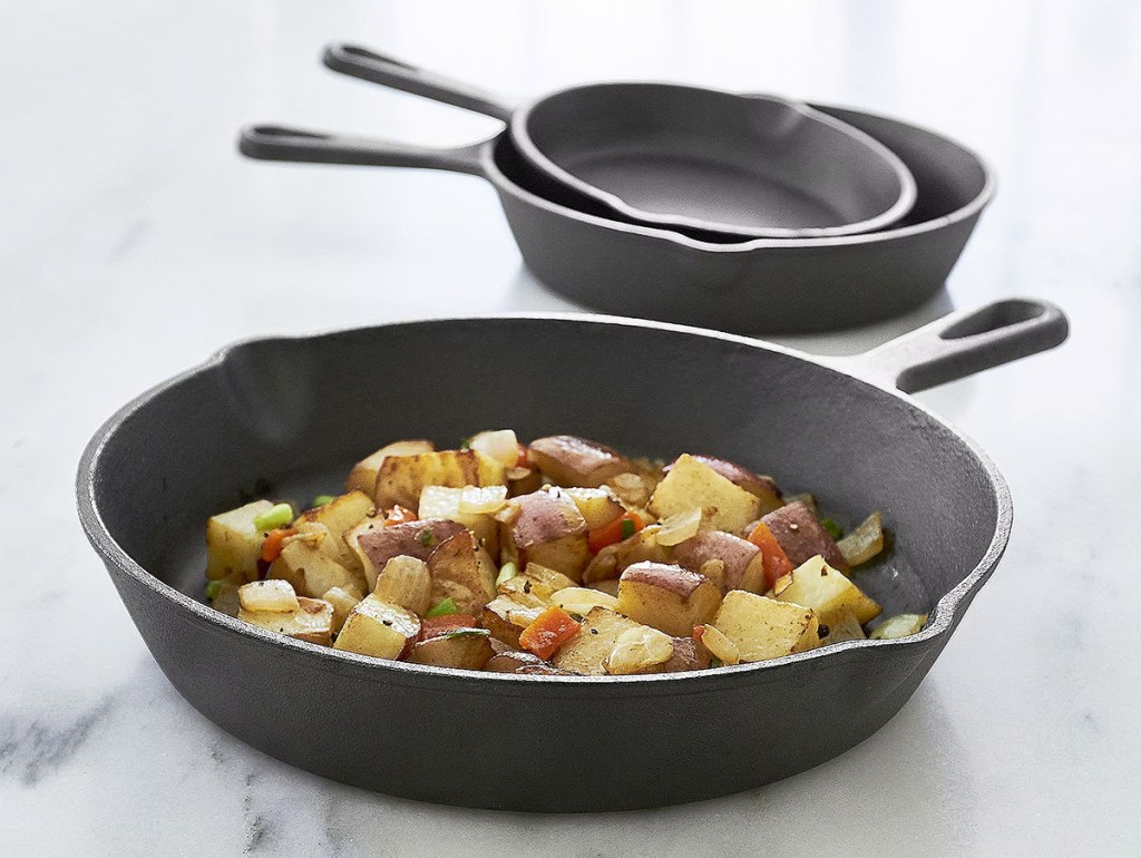 three cast iron pans on counter