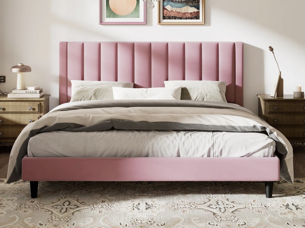 bed with pink upholstered headboard and bed frame