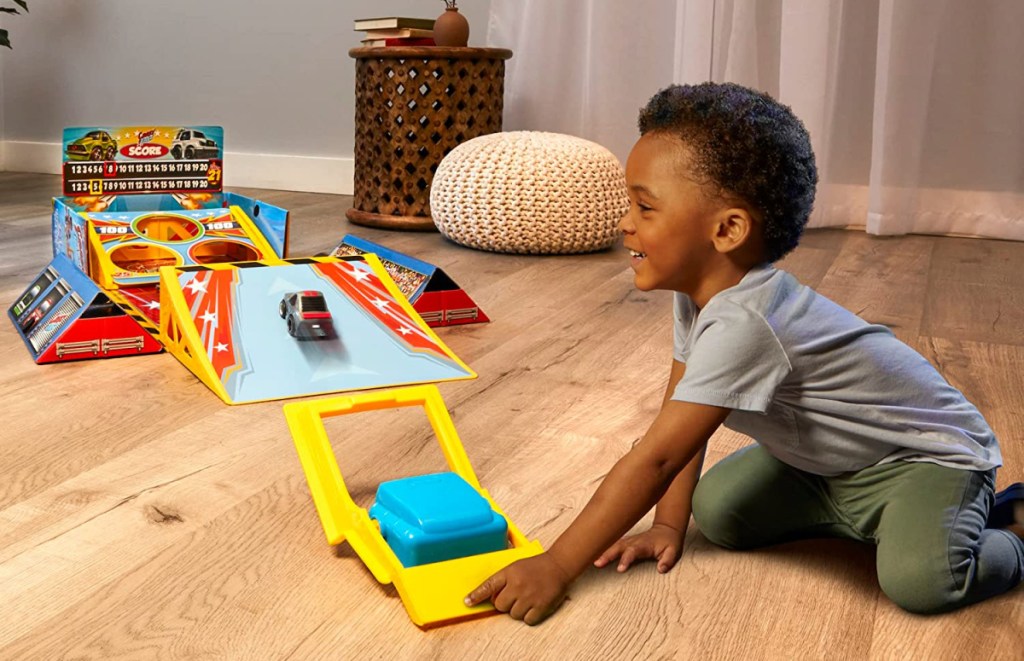 boy playing with a little tikes my first cars playset