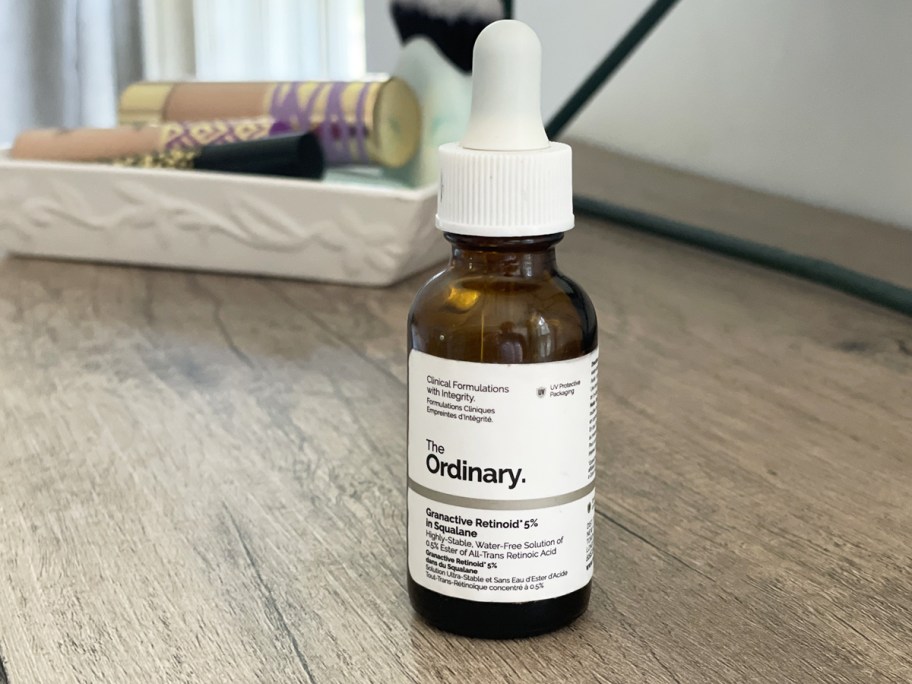 bottle of The Ordinary Granactive Retinoid 2% Emulsion on wood table