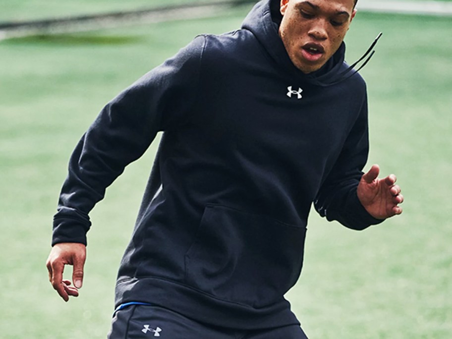 man wearing black under armour hoodie