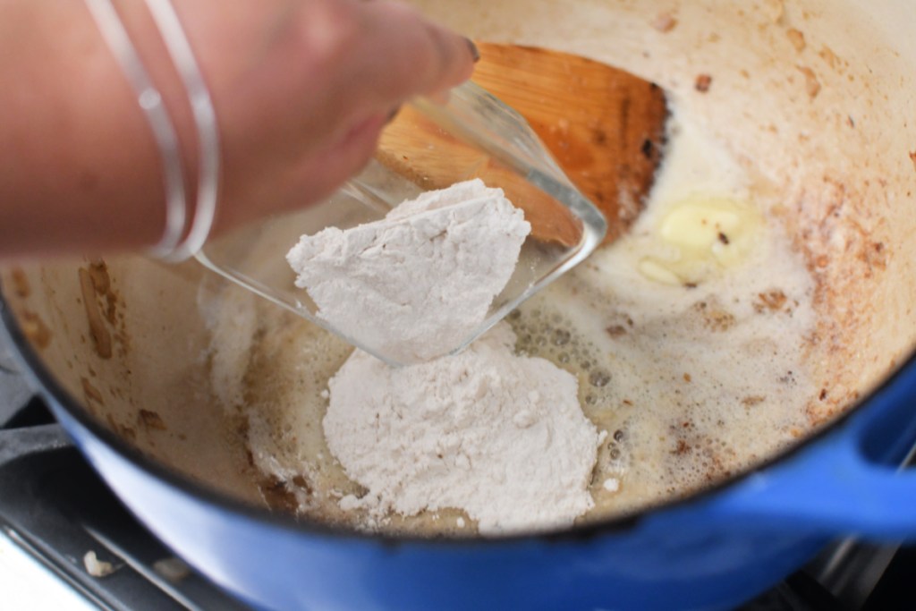 adding flour to butter