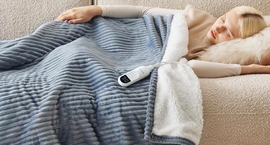 woman laying on couch with ribbed gray blue heated blanket