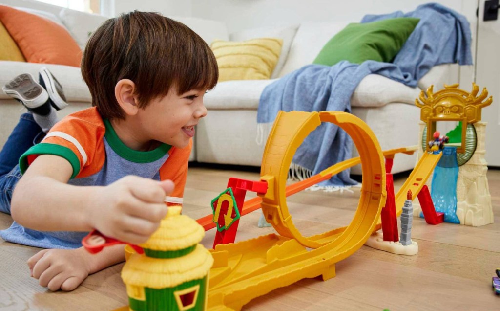 child playing with Hot Wheels The Super Mario Bros. Movie Jungle Kingdom Raceway