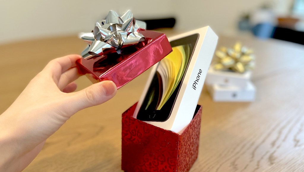 iphone box in red holiday box with bow on table