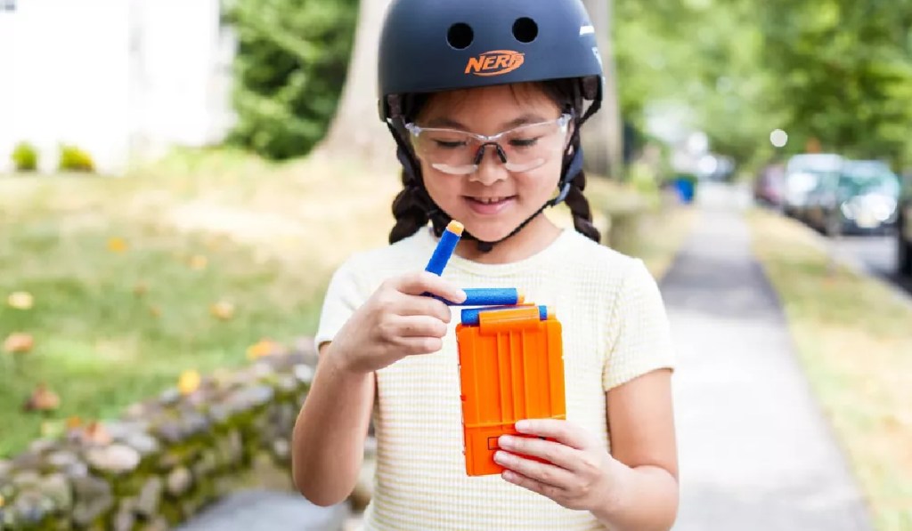 girl refilling a nerf blaster scooter cartridge