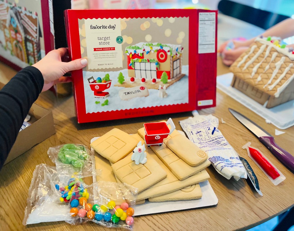 hand holding target store cookie house box with supplies on table