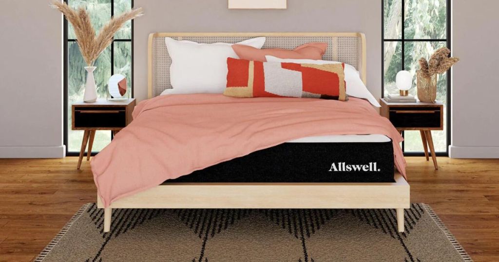 Allswell mattress with pink onlineforter and pillows on bed in bedroom