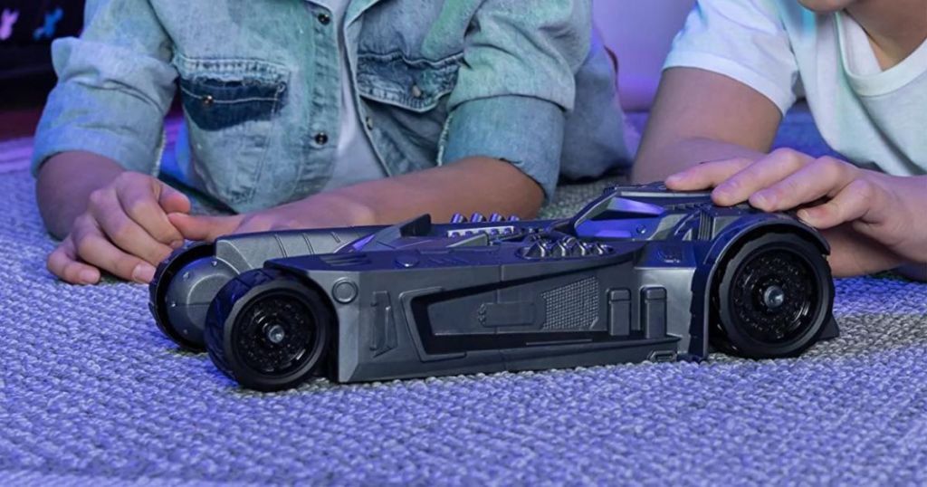 two boys playing with Batman 2 in 1 transforming vehicle as the batmobile