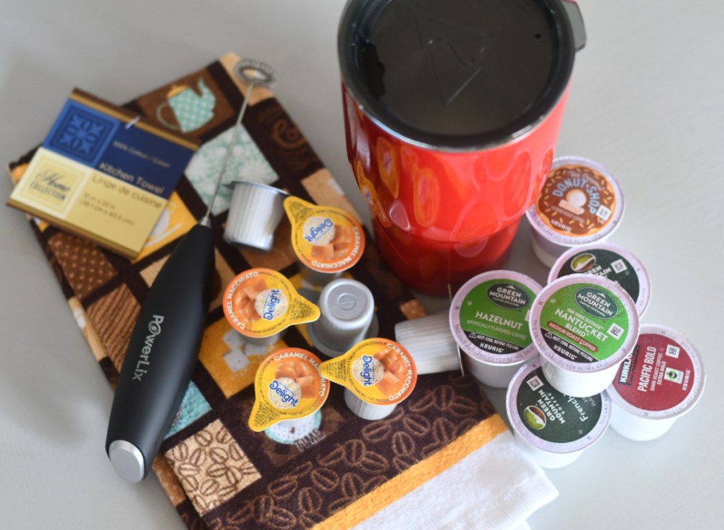 Coffee Tumbler with coffee pods and a milk frother