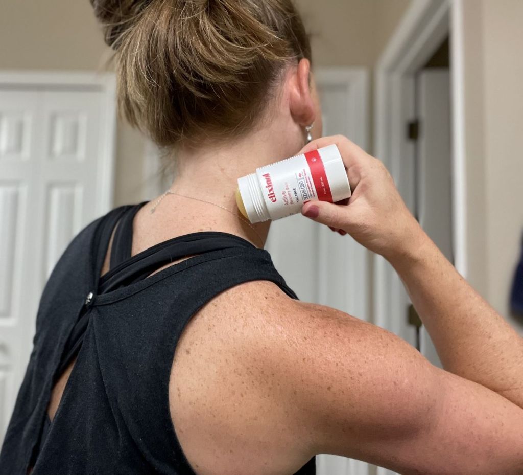 woman using an Elixinol Active Balm