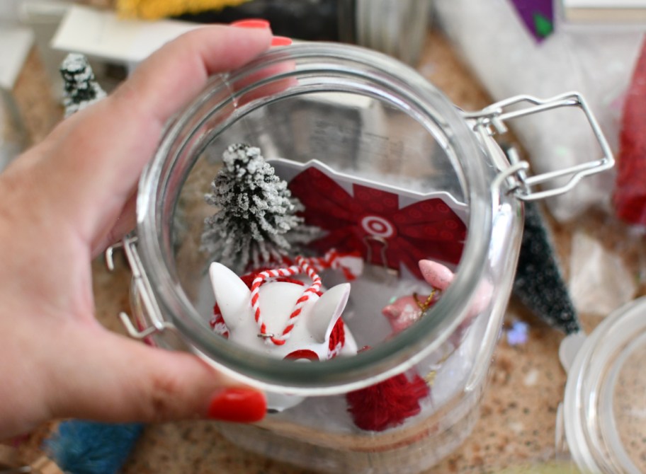 Woman holding a diy mason jar snow globe