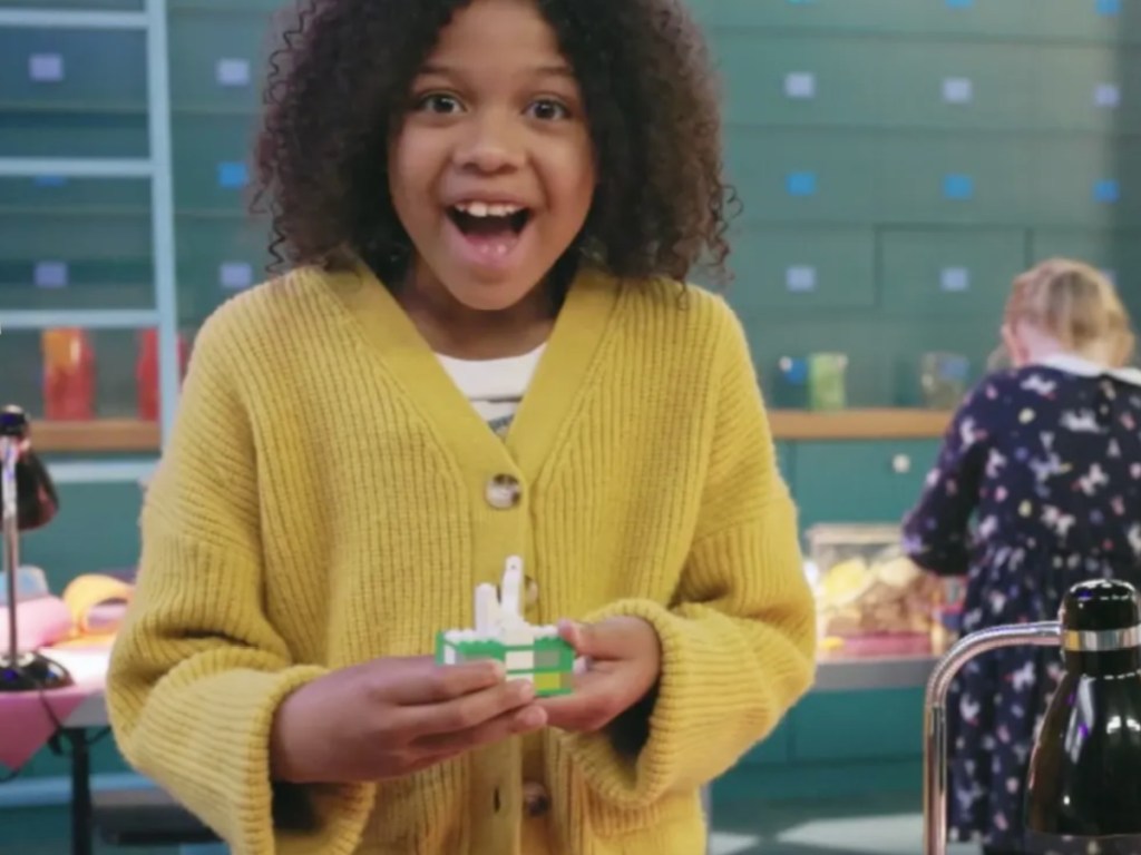 Girl holding LEGO brick