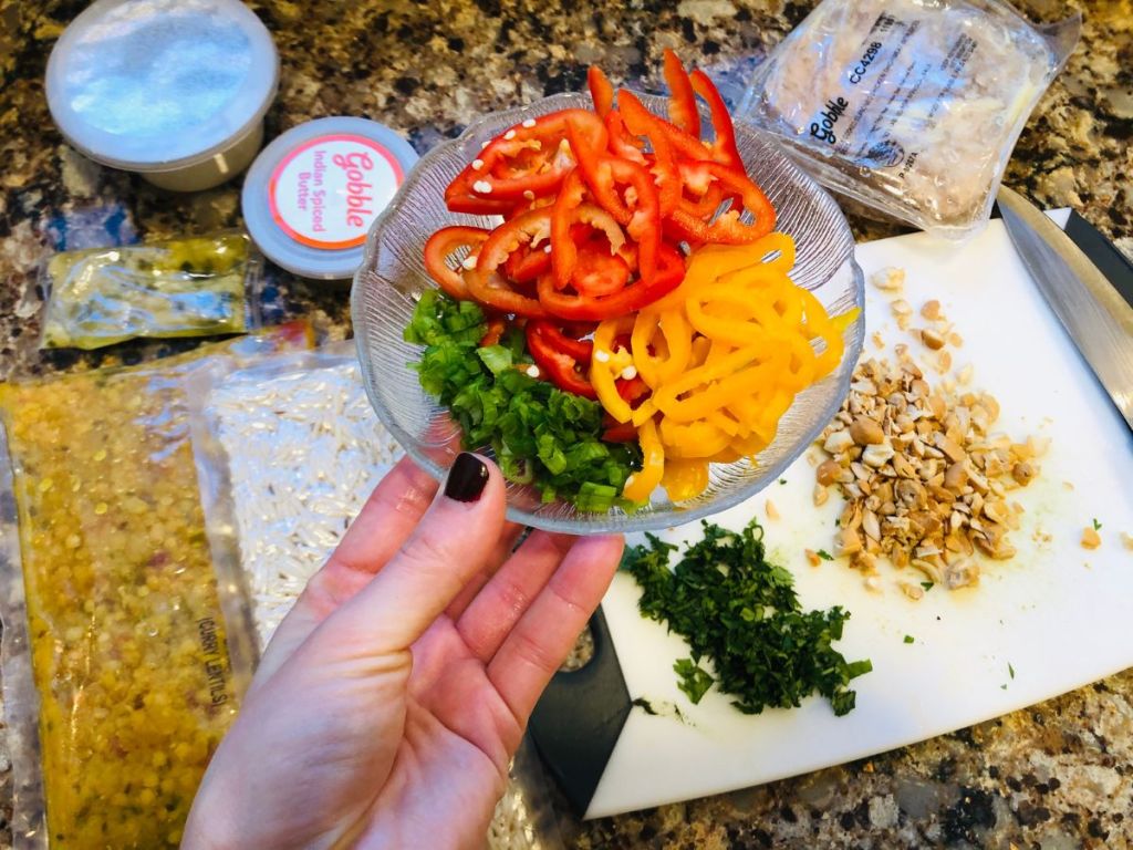 A hand holding Gobble Box veggies