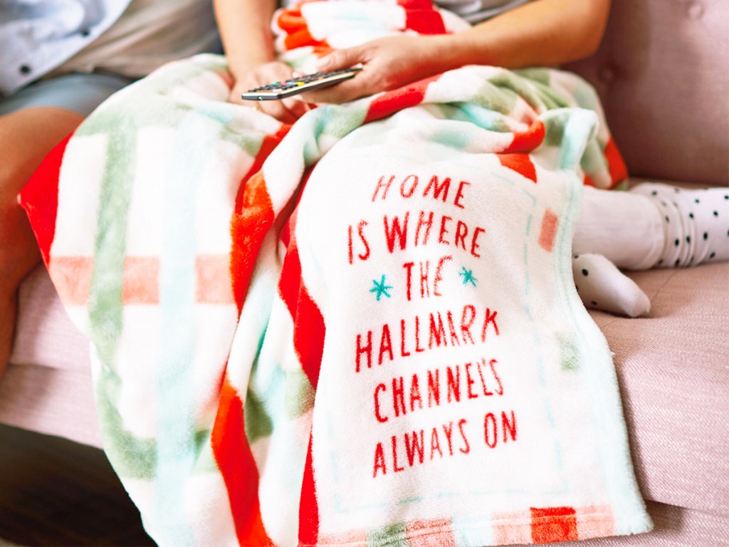 person on couch under plaid hallmark movie throw