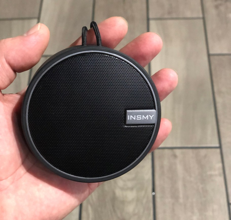 Hand holding a waterproof bluetooth speaker