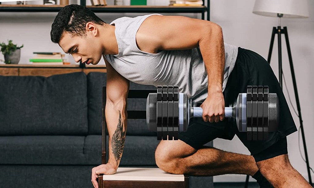 man using adjustable dumbbell