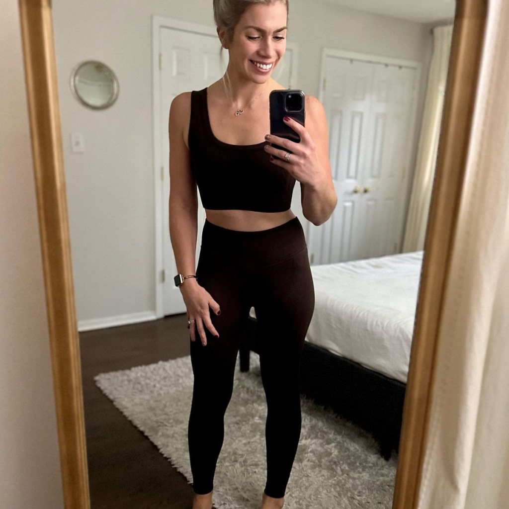 woman in workout gear taking selfie