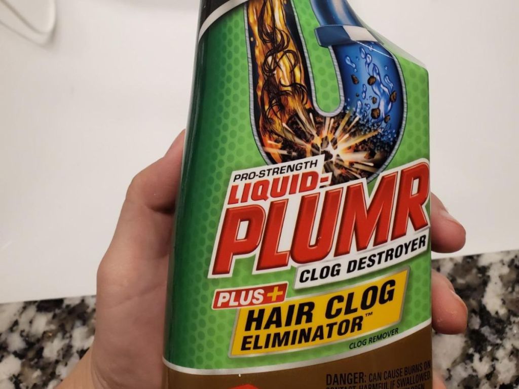 hand holding a bottle of Liquid Plumr